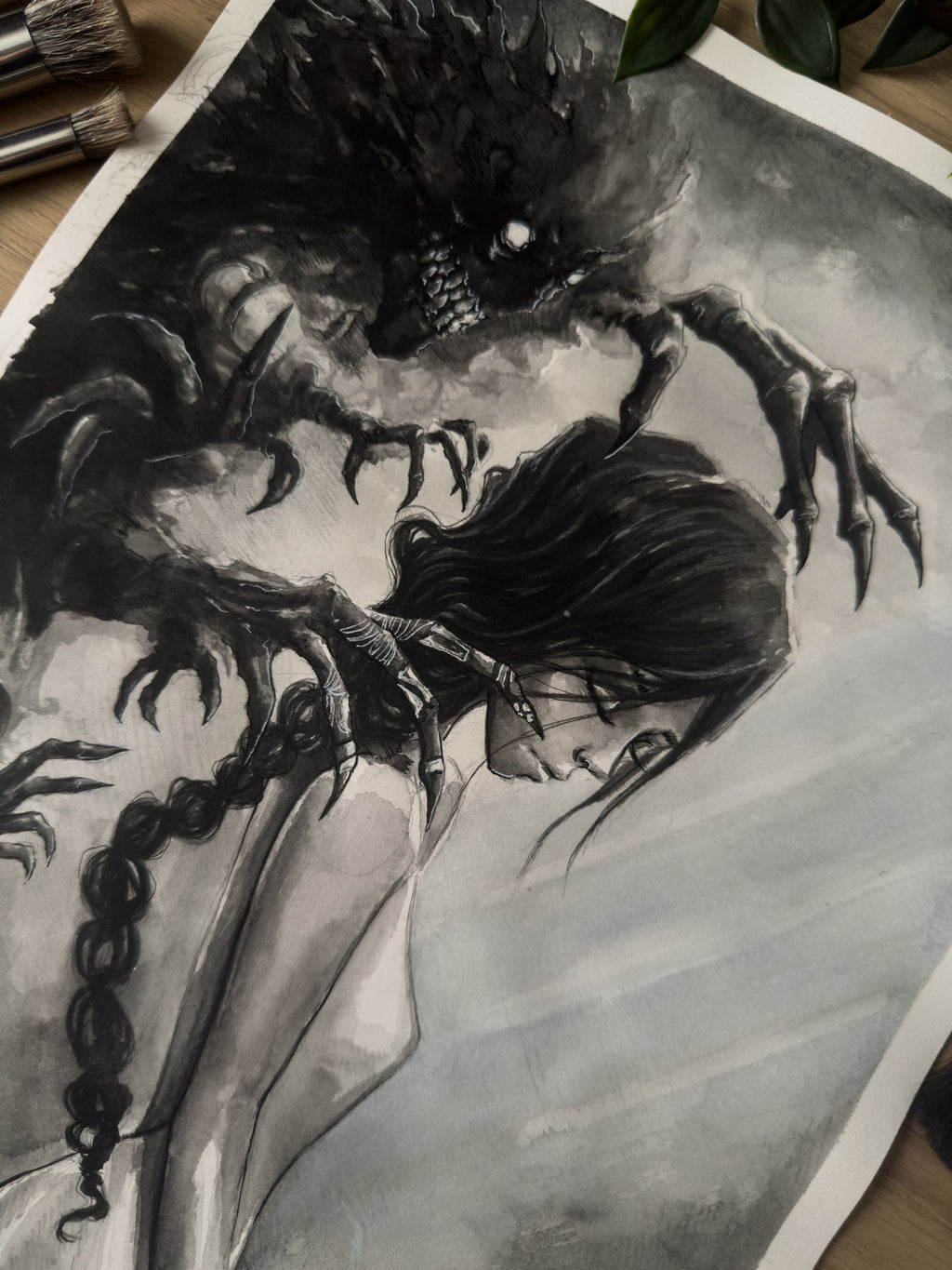 Death spirit grasping at a woman painted with watercolor in a Japanese inspired style in black and white top down close up
