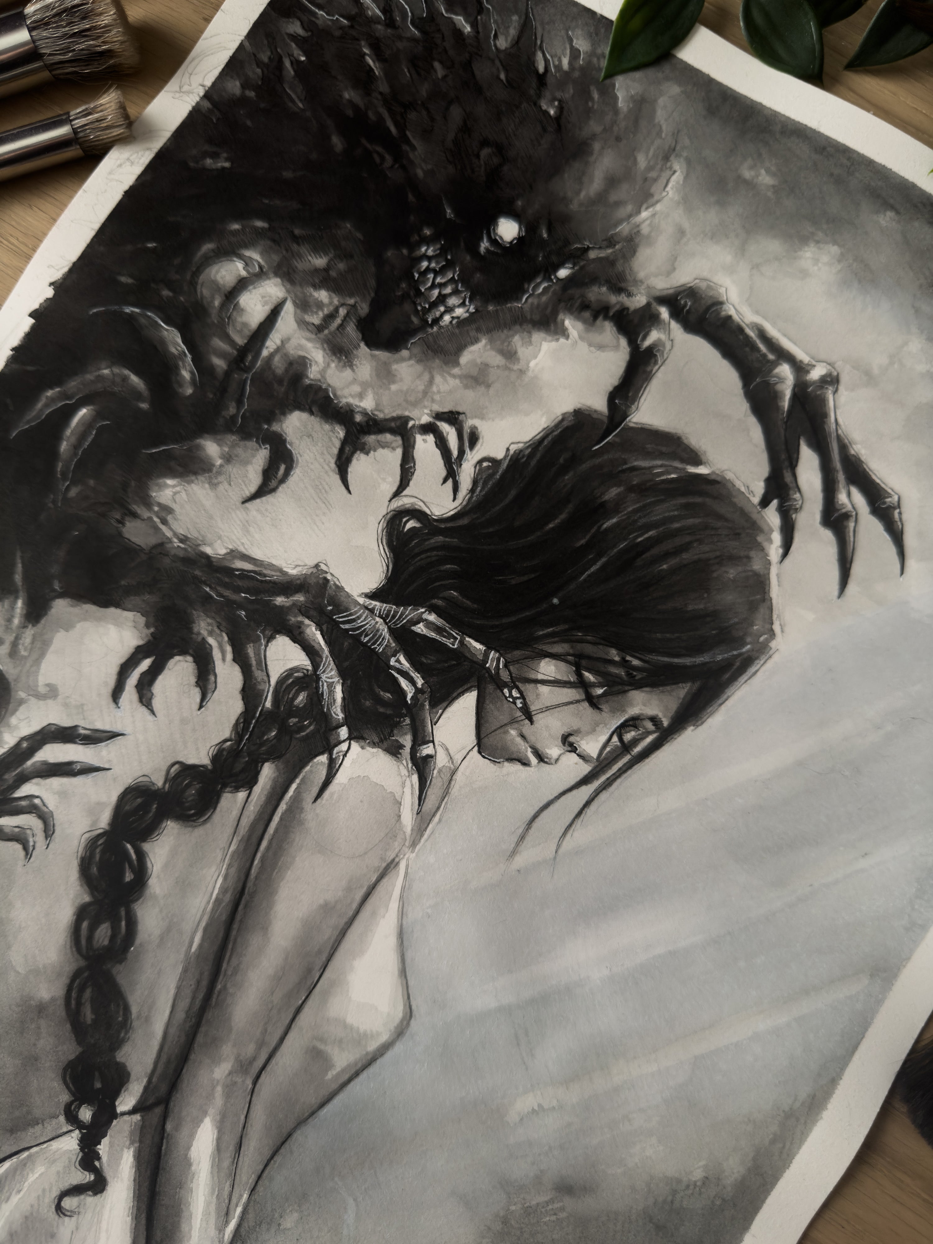 Death spirit grasping at a woman painted with watercolor in a Japanese inspired style in black and white top down close up